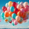 colorful balloons set against clear blue sky backdrop