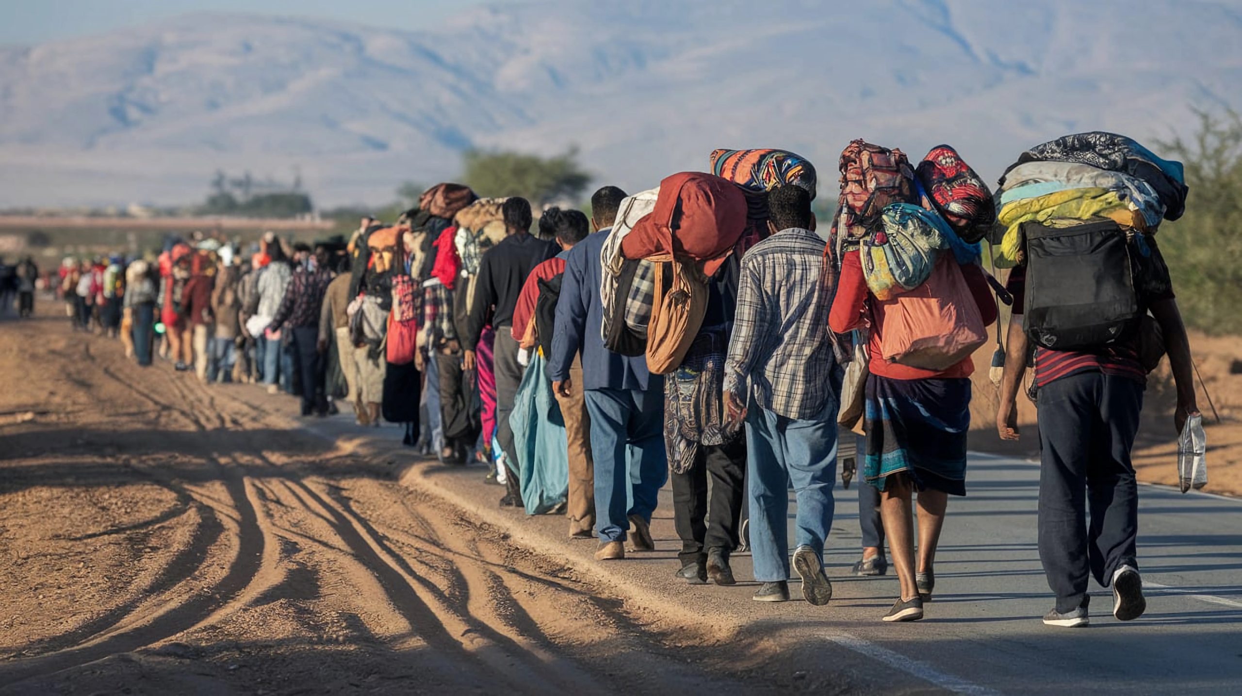 large group people are standing line with mountains background scaled