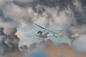 rescue helicopter races against oncoming storm severe weather modern attack helicopter with with weapons