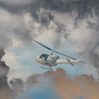rescue helicopter races against oncoming storm severe weather modern attack helicopter with with weapons
