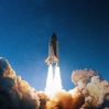 rocket launch into blue starry sky space wallpaper