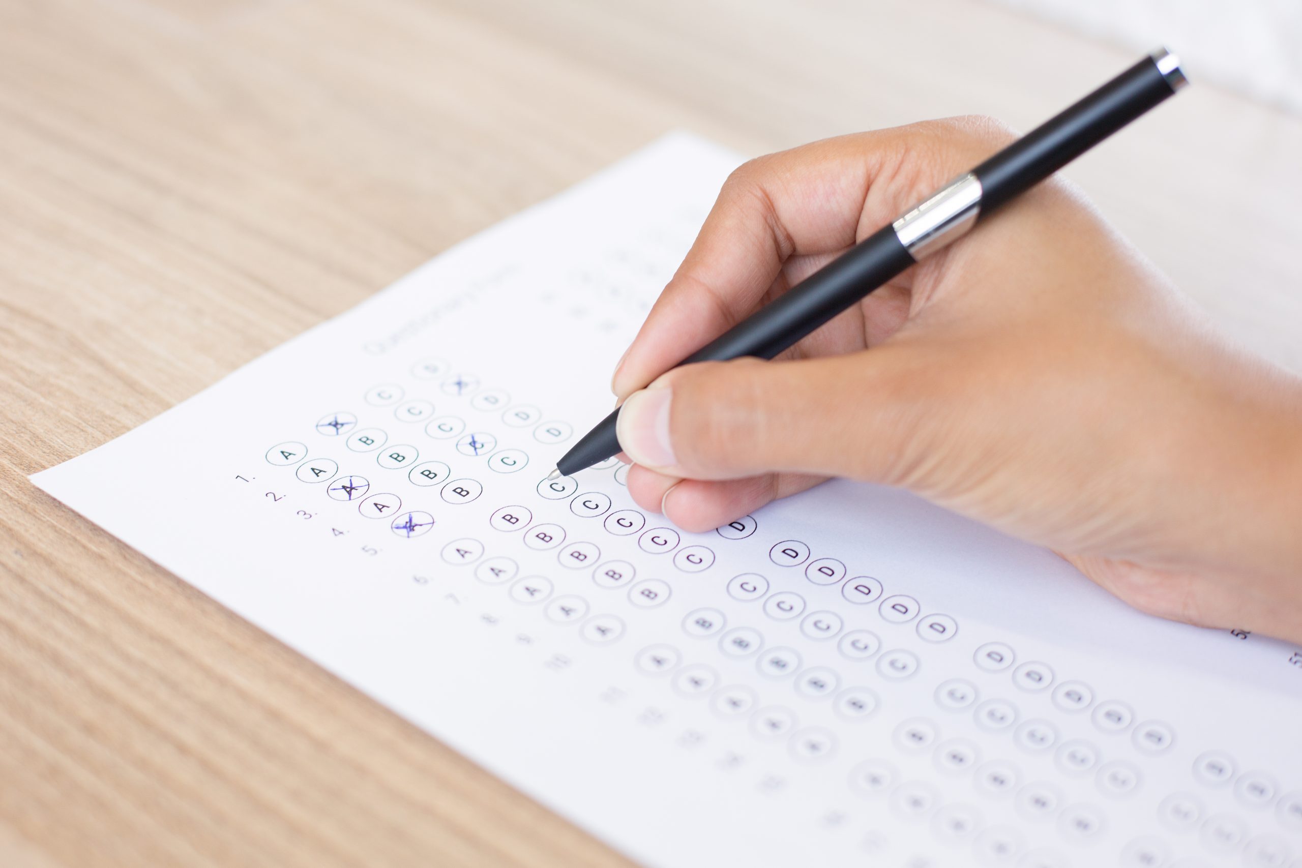 closeup person filling out questionary form scaled