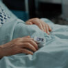 close up oximeter patient hospital ward bed medical facility old man waiting results