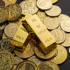 coins gold bars scattered table