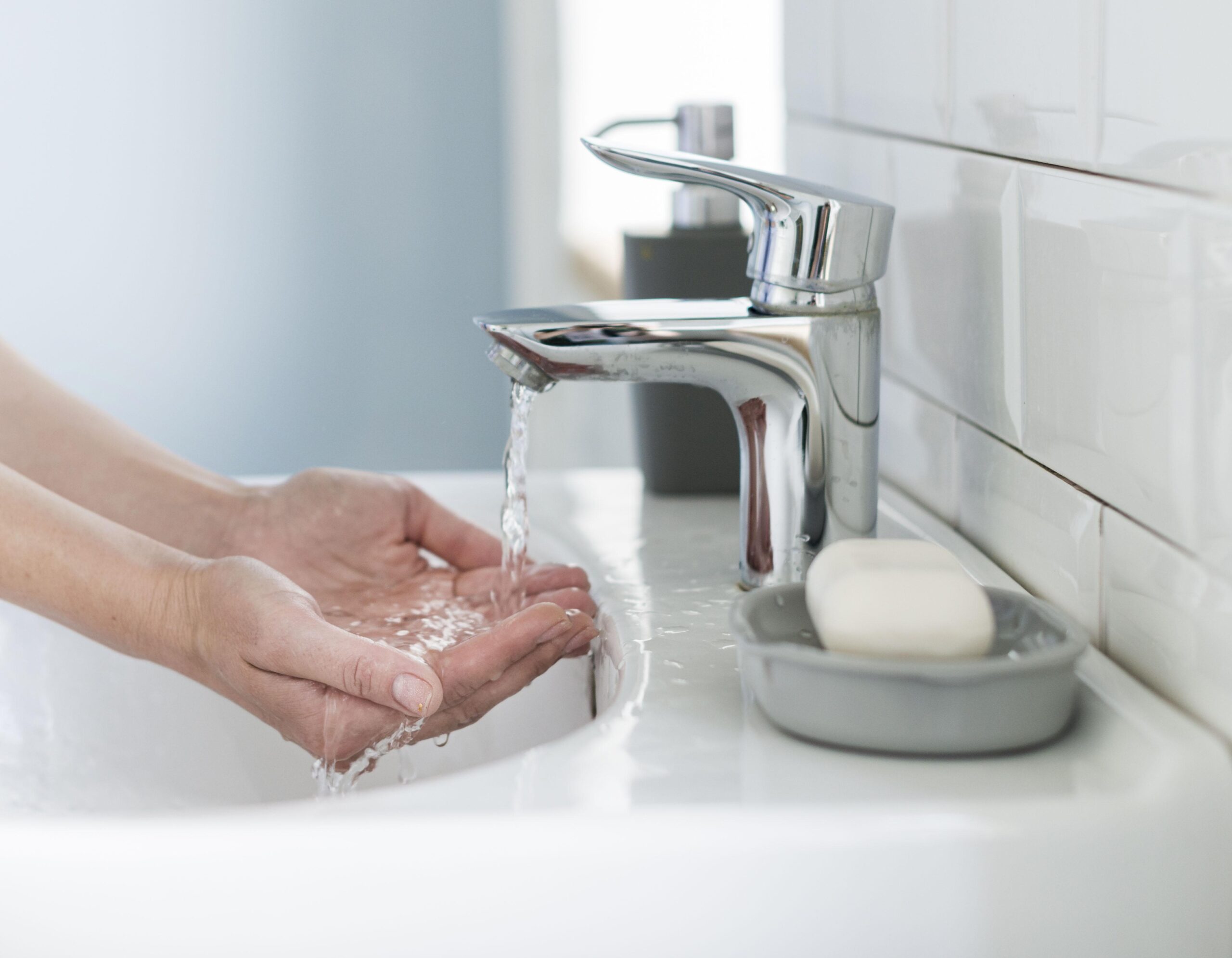 side view person preparing wash their hands sink 1 scaled