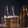 glass bottles beer with glass ice dark background