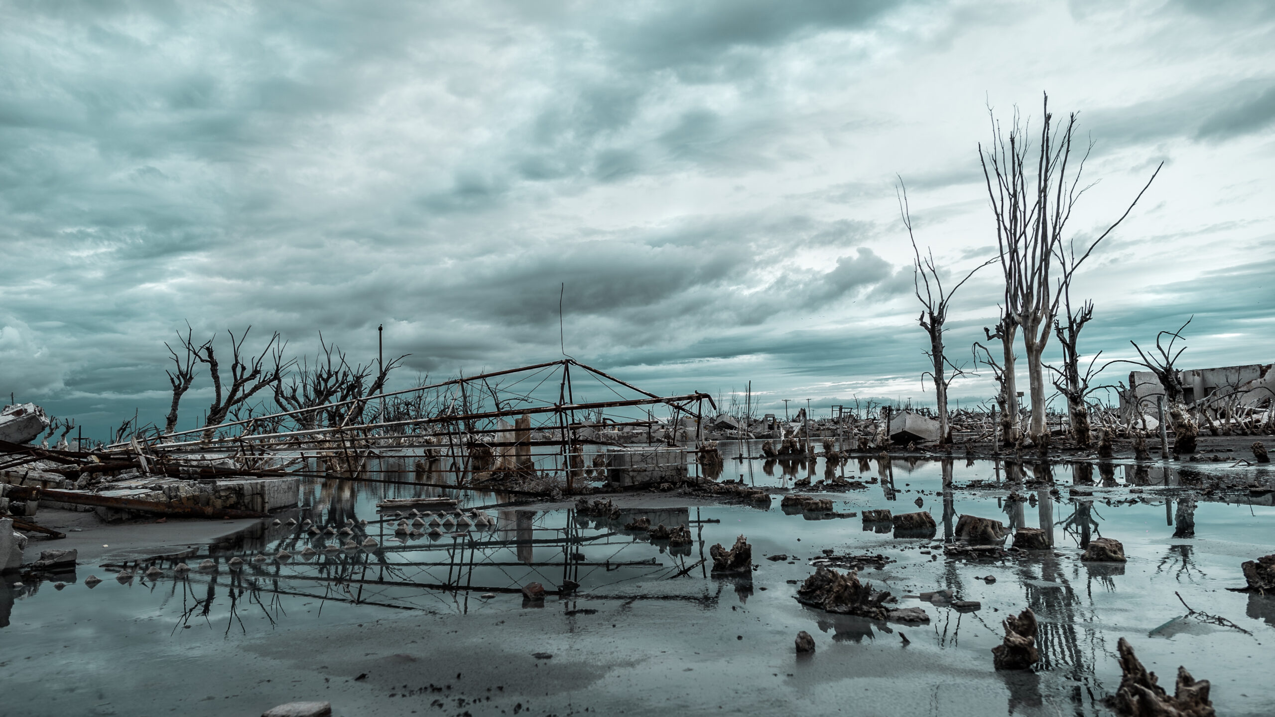 landscape building ruins bare trees water cloudy sky gloomy day scaled