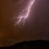 lightning night sky mountains with trees