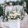 column with rich bouquet roses stands outside