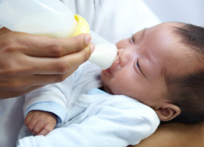 baby with cleft lip milk mom feeding from bottle nutrition health wellness formula newborn hand mother feed child development growth healthy diet food lunch home