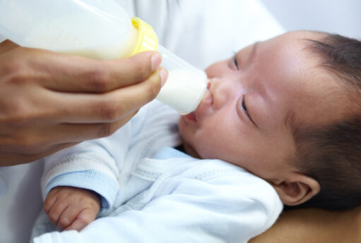 baby with cleft lip milk mom feeding from bottle nutrition health wellness formula newborn hand mother feed child development growth healthy diet food lunch home