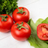 close up view vegetables as coriander tomato spinach wooden table