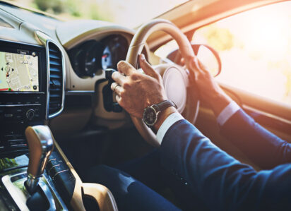 man hands travel driving car commute steering wheel en route business trip transport navigation display screen professional driver work journey automobile with gps map