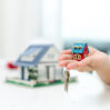 real estate agent with house model keys