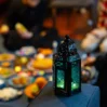 An open Quran rests next to a bowl of dates and a decorated lantern GettyImages 1368465583 5
